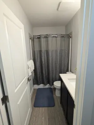 a bathroom with a toilet and a sink and a shower at DaraJay Cozy Home in Calgary