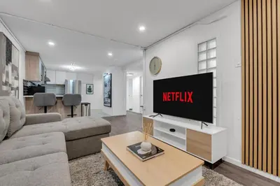 a living room with a flat screen tv on a wall at 5 bed Luxury Home Steps to DT, River and Hospital in Calgary
