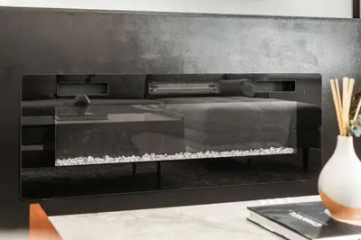 a black fire place with a vase on a table at 5 bed Luxury Home Steps to DT, River and Hospital in Calgary