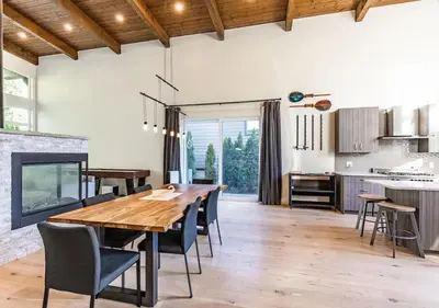 a kitchen and dining room with a wooden table and chairs at Large Modern Home in Squamish in Squamish