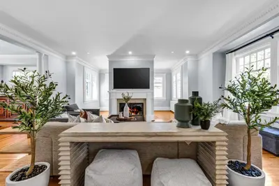 a living room with a fireplace and a tv at West King Edward Luxury Guest Home in Vancouver