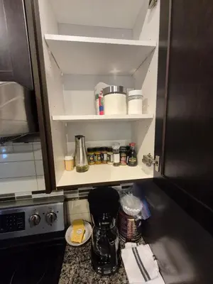 a kitchen with a cupboard with food items on it at Sean Comfy Home in Edmonton