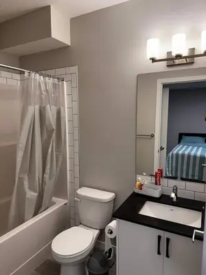 a bathroom with a white toilet and a sink at Newly Built 2-Bedroom, 2 full bath Basement Suite in Calgary