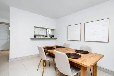 a dining room with a wooden table and chairs at Chic Central 4BDRM Home-King Bed-AirHockey-Mins DT in Edmonton