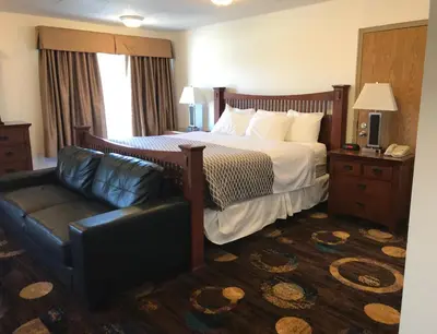 a hotel room with a bed and a couch at Stonebridge Hotel in Fort McMurray