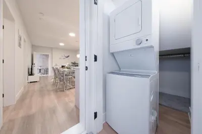 a kitchen and dining room with a white refrigerator at Newly Built Cozy 2BR Suite Langley Event Center in Langley