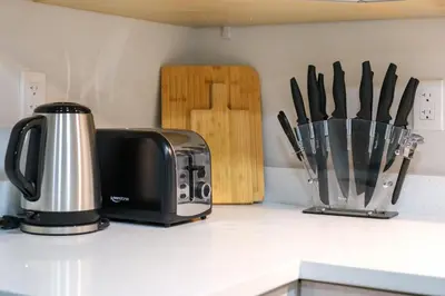 a kitchen counter top with a toaster and a knife block at Newly Built Cozy 2BR Suite Langley Event Center in Langley