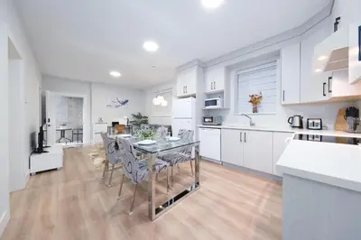 a kitchen and dining room with a table and chairs at Newly Built Cozy 2BR Suite Langley Event Center in Langley