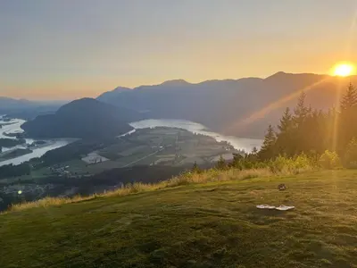 a sunset on a hill with a view of a river at Peaks & Waters at Harrison Mills in Agassiz