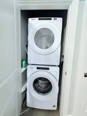 a white washer and dryer in a small room at Peaks & Waters at Harrison Mills in Agassiz