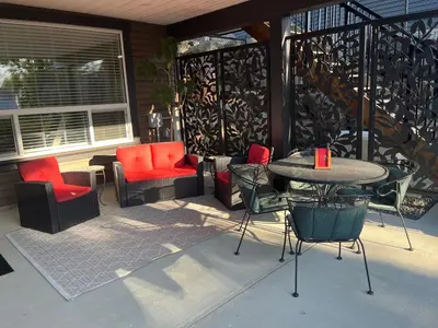 a patio with chairs and a table and a table and chairs at Peaks & Waters at Harrison Mills in Agassiz