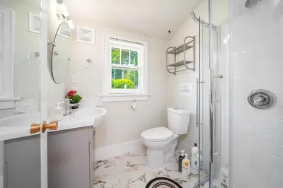 a bathroom with a toilet and a sink and a shower at Cozy three bedroom House in Vancouver West in Vancouver