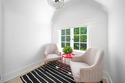 two chairs and a table in a room with a window at Cozy three bedroom House in Vancouver West in Vancouver