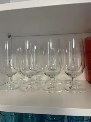a row of wine glasses sitting on a shelf at Cozy three bedroom House in Vancouver West in Vancouver