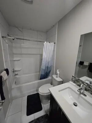 a bathroom with a sink and a toilet and a shower at 2 Bedroom Secondary Suite in Calgary