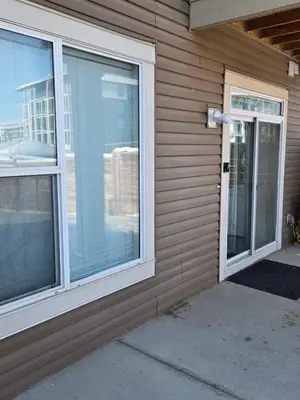 a house with a sliding glass door and a window at 2 Bedroom Secondary Suite in Calgary