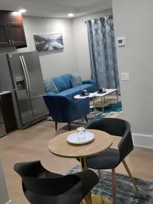 a living room with a blue couch and a table at 2 Bedroom Secondary Suite in Calgary