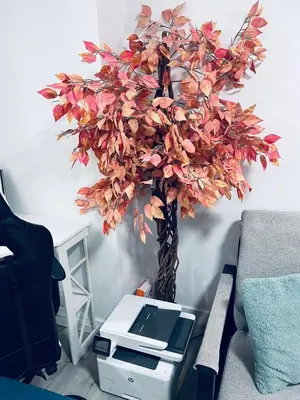 a fake tree in a room with a printer at Modern 2 bedroom guest suite in Calgary