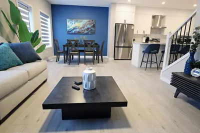 a living room with a couch and a table at Edgemont Escape Large Groups, River Cree, WEM, Disney in Edmonton
