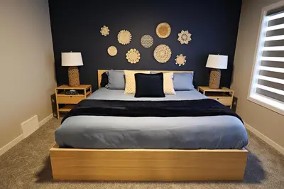 a bedroom with a large bed with two night stands at Edgemont Retreat, Groups, River Cree, WEM, Disney in Edmonton