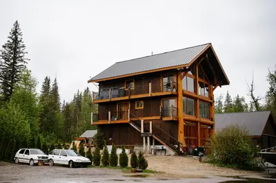 a large house with two cars parked in front of it at River Safari Eagles Nest in Blue River