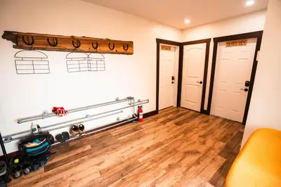 a room with two doors and a hard wood floor at River Safari Eagles Nest in Blue River