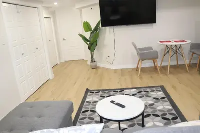 a living room with a tv and a couch and a table at DJoshuas place in Edmonton