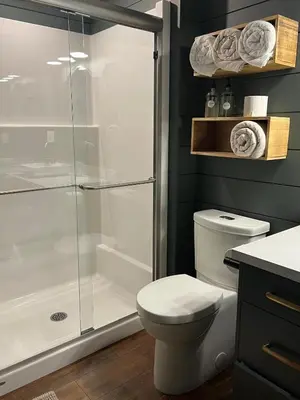 a bathroom with a shower stall and a toilet at Sagebrush Caboose in Okanagan Falls