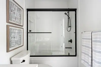 a bathroom with a shower with a glass door at Mountain Suite - Ocean View Fire Pit - Fully Equipped Kitchen - WD in Nanaimo