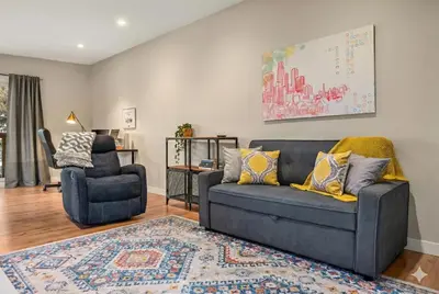 a living room with a couch and a chair at Comfy, Cozy, Central Calgary, 2BR and 1BTH in Calgary