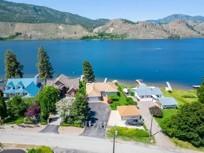 an aerial view of a house with a lake at Skaha Lakefront Inn in Okanagan Falls