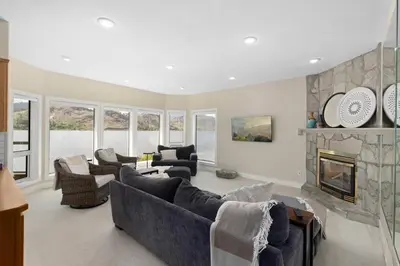 a living room with couches and a fireplace at Skaha Lakefront Inn in Okanagan Falls