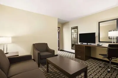 a hotel room with a desk and a computer at Ramada by Wyndham Edson in Edson