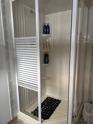 a walkin shower with a glass door in a bathroom at Amazing Views, Northern Lights, Stargazing Entire Guest Suite in Golden, BC Canada in Golden