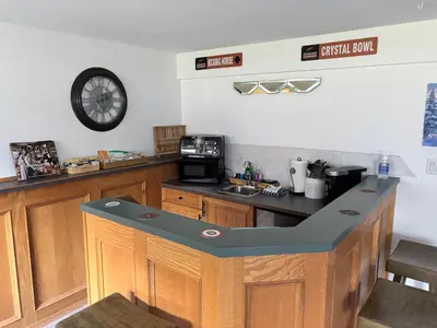 a kitchen with a counter and a clock on the wall at Amazing Views, Northern Lights, Stargazing Entire Guest Suite in Golden, BC Canada in Golden