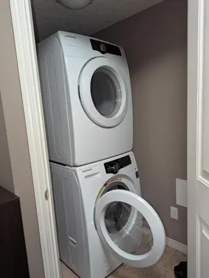 a washing machine and a dryer in a room at Well located Condo in North of Calgary in Calgary