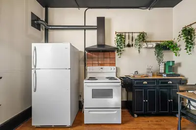 a kitchen with a white refrigerator and a stove at The Accountant - Sleeps 3 Guests - DT Drumheller in Drumheller