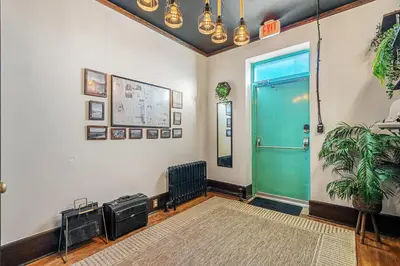 a hallway with a green door and a plant at The Accountant - Sleeps 3 Guests - DT Drumheller in Drumheller