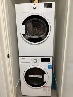 a washing machine and a dryer in a room at Beautiful 2 Bedroom suite in White Rock