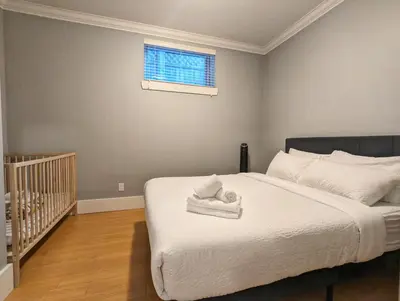 a bedroom with a bed with towels on it at Cozy home in Vancouver in Vancouver