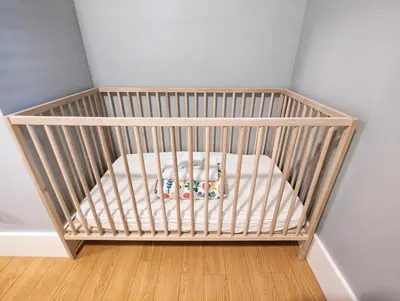 a crib with a toy in a room at Cozy home in Vancouver in Vancouver