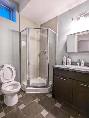 a bathroom with a shower and a toilet and a sink at Cozy home in Vancouver in Vancouver