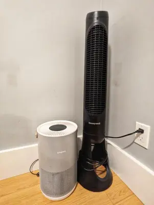 a fan and a speaker on a table next to a wall at Cozy home in Vancouver in Vancouver