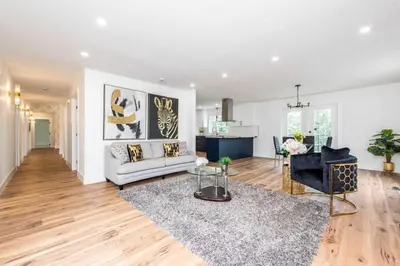 a living room with a couch and a table at Walkout Bungalow with Pond Views in Balzac