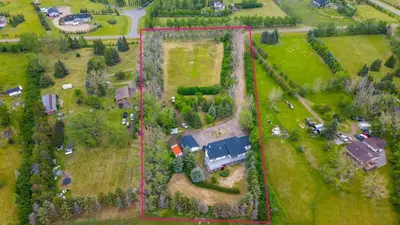 an aerial view of a house in a field at Walkout Bungalow with Pond Views in Balzac