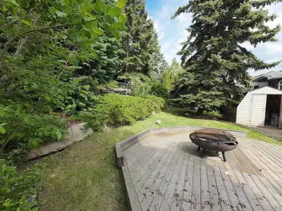 a wooden deck with a bench on top of it at The Luxe Escape Calgary I 3BR Vacation Home in Calgary