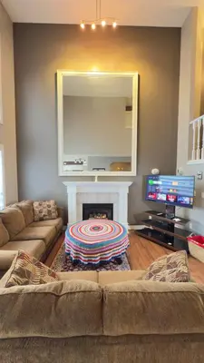 a living room with a couch and a fireplace at The Ridge Escape-3BR Deluxe Stay in Calgary