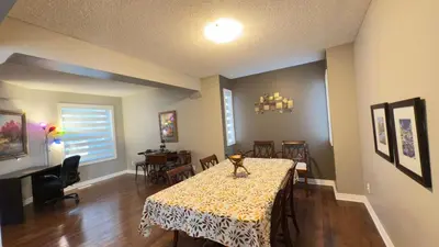 a dining room with a table and some chairs at The Ridge Escape-3BR Deluxe Stay in Calgary