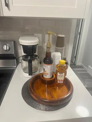 a counter top with a wooden tray with a coffee maker at Global Family Canada in Calgary