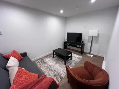 a living room with a couch and a television at Cozy home away from home in Calgary